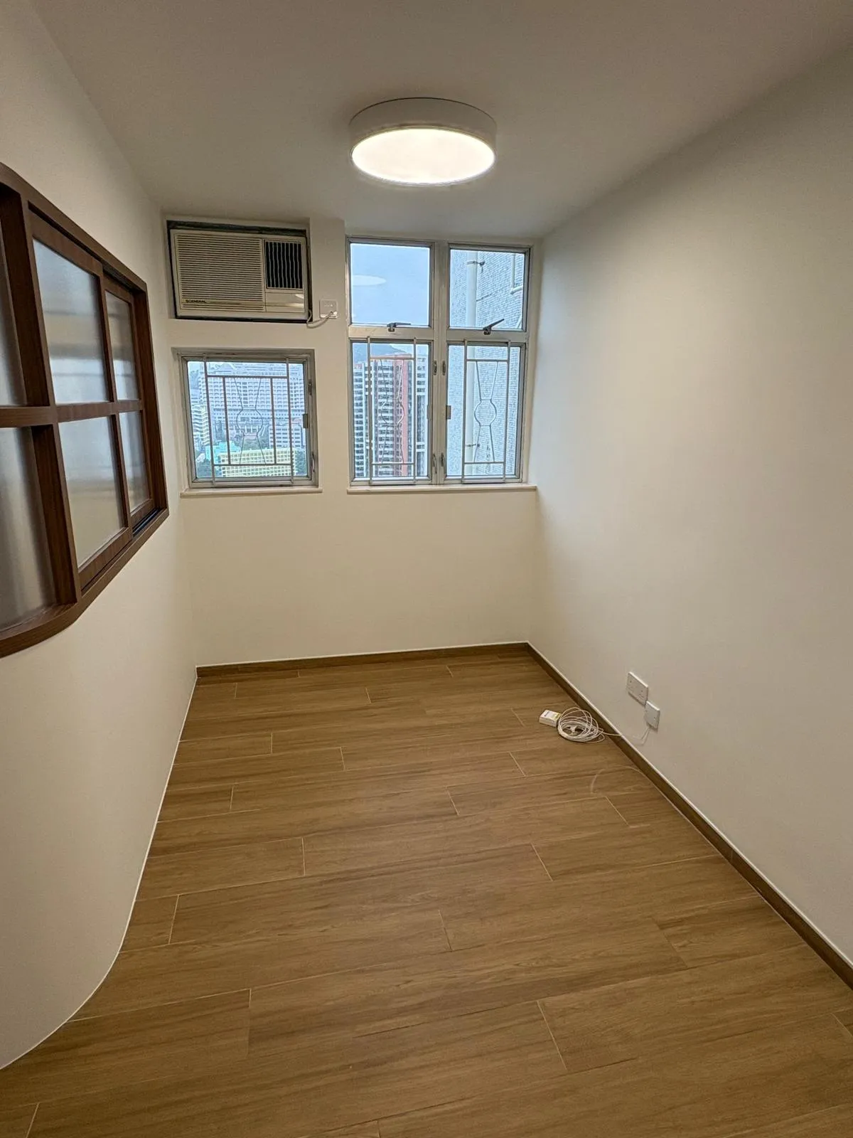 Full bedroom view with air conditioning unit and window