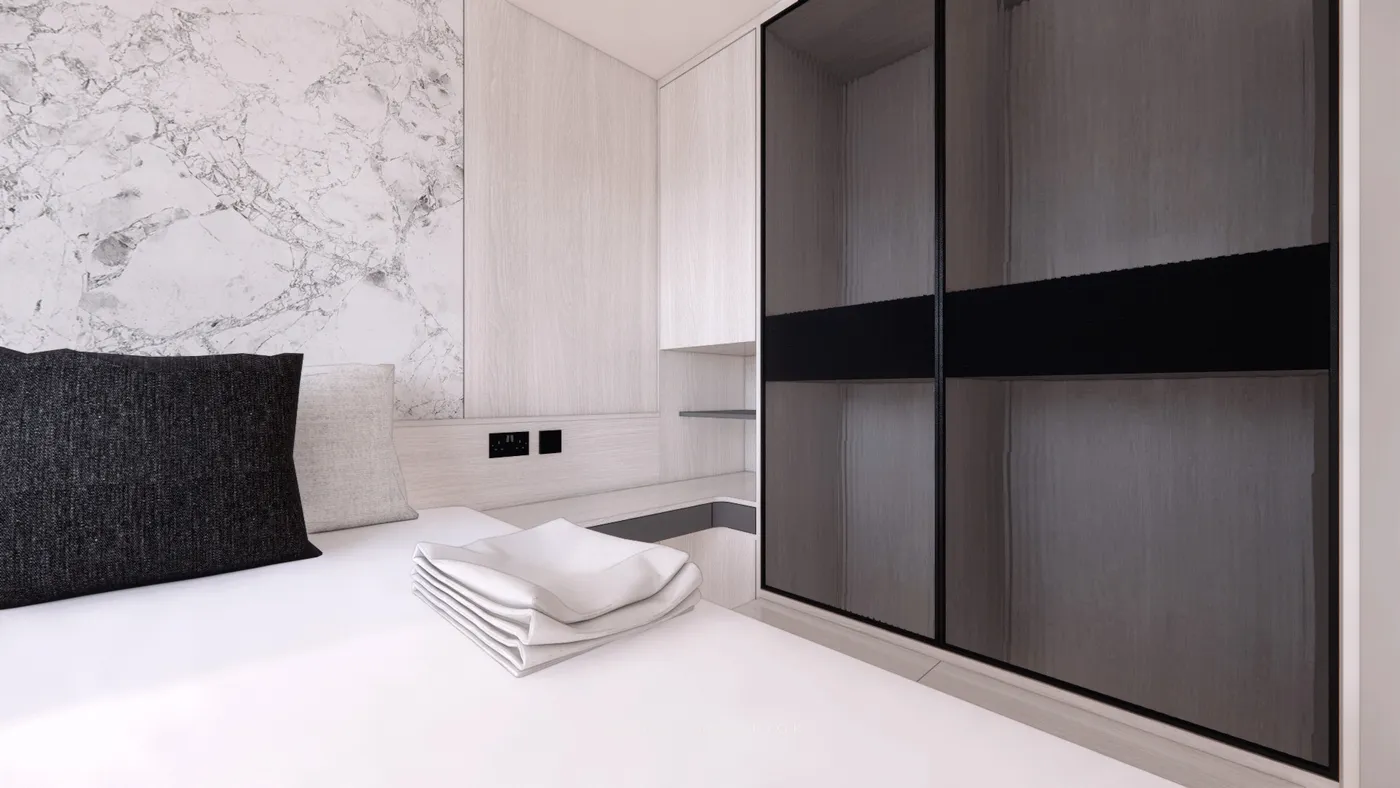 Bedroom headboard wall in marble-effect finish with a black sliding-door wardrobe
