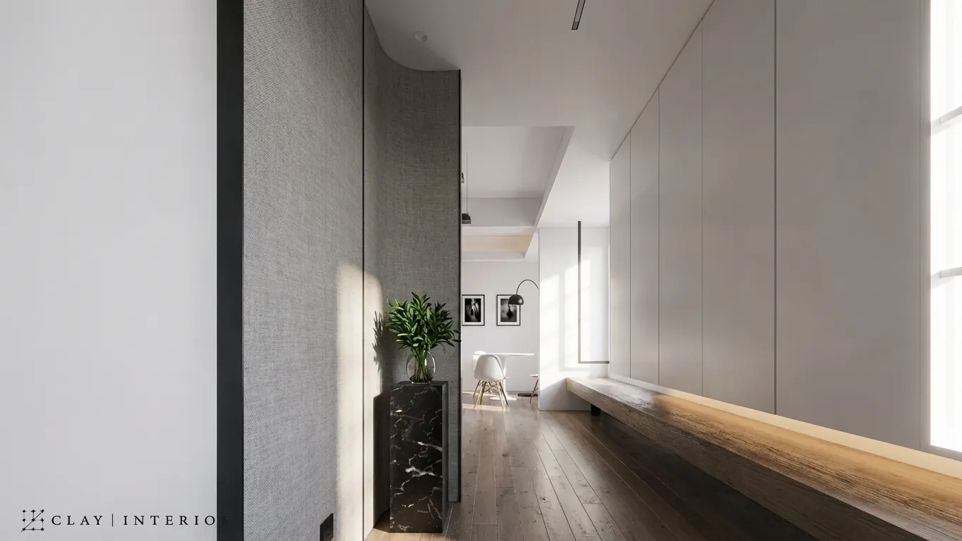 Corridor corner with a curved fabric screen wall, a black marble-effect planter, and greenery
