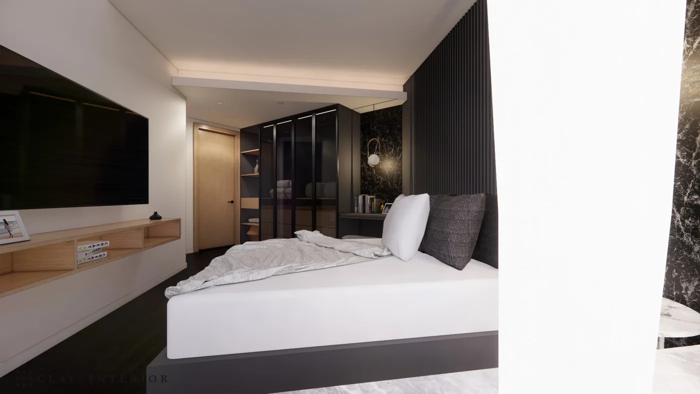Full bedroom view with the bed, glass sliding-door wardrobe, and TV wall composed as one