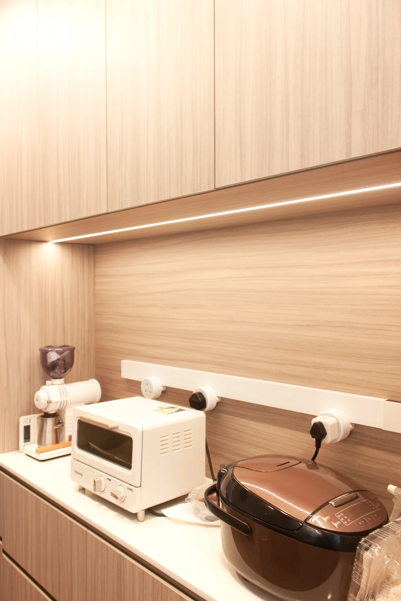 Kitchen countertop appliance storage, with a toaster and rice cooker neatly arranged