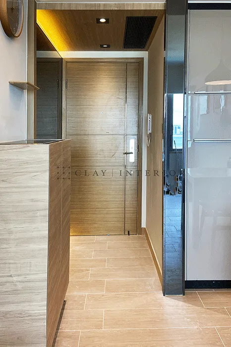 Entrance with wood-grain front door and beige textured floor tiles