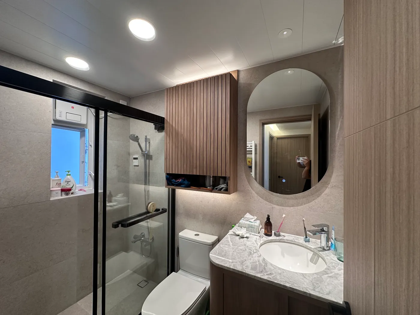 Bathroom shower, toilet, and marble-effect vanity counter