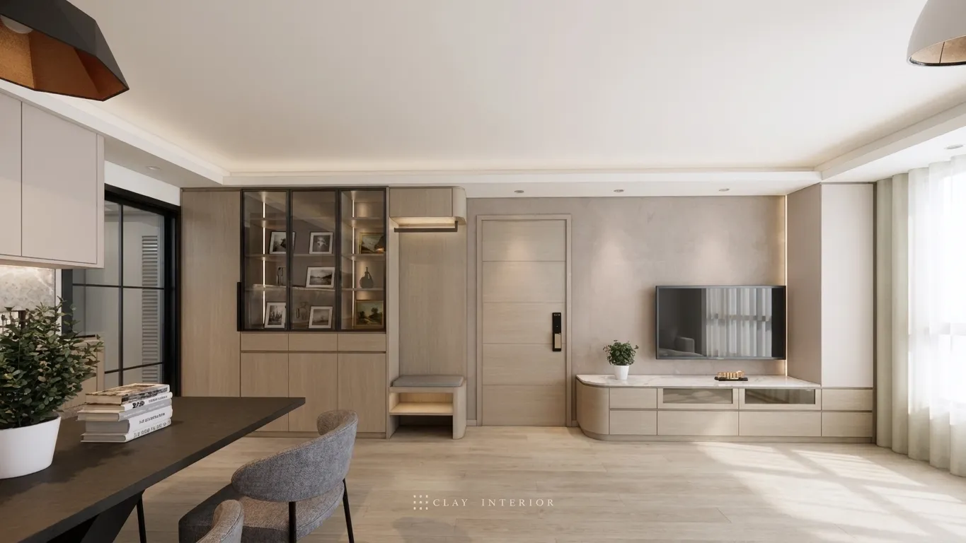 Corner of the living and dining area, with a curved TV console and display shelving