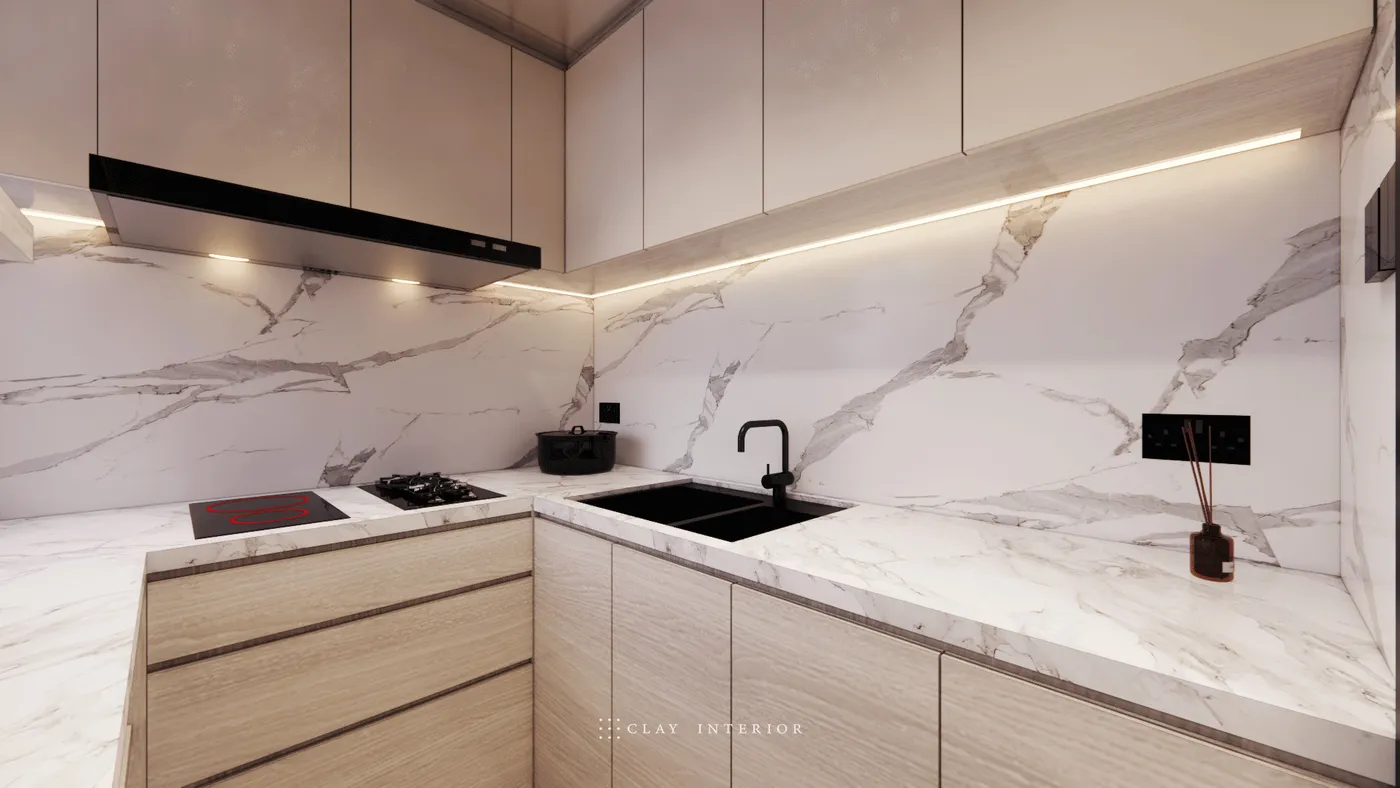 Kitchen cooking area with marble-effect wall panelling, black tapware, and stove