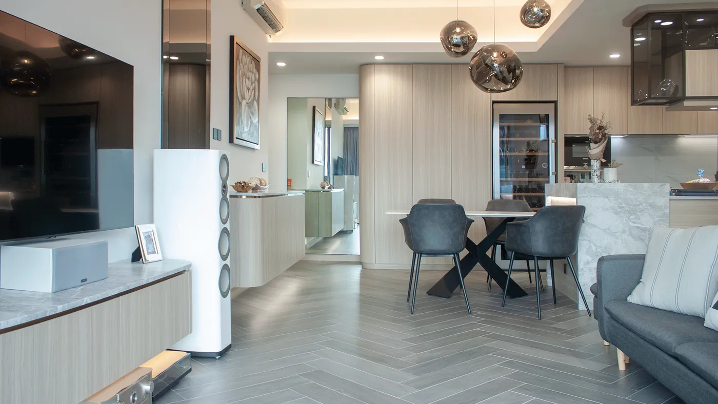 Full view of the living and dining area with herringbone wood-look flooring and a blue-and-gold statement artwork