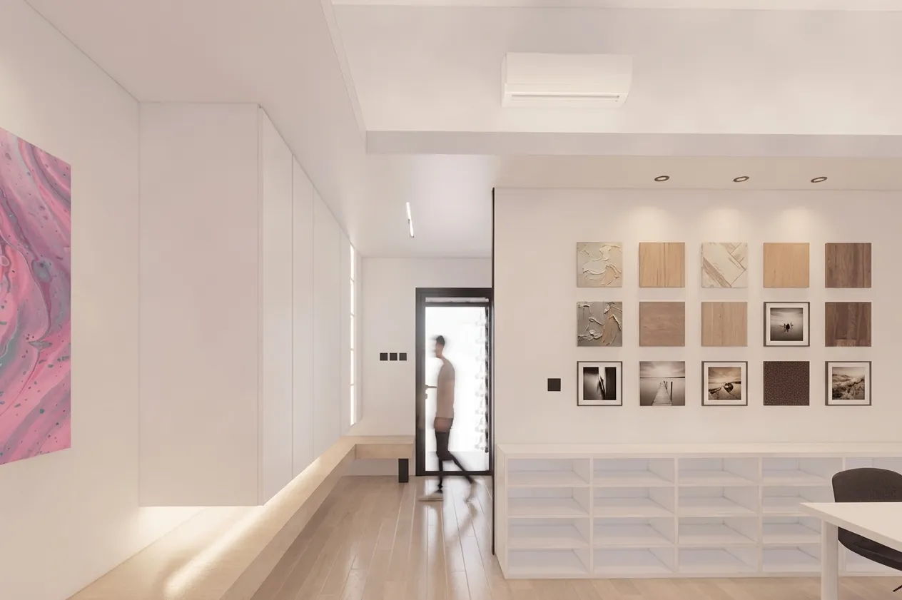 Corridor display wall showing wood-grain material samples and black-and-white photography, beside white open shelving