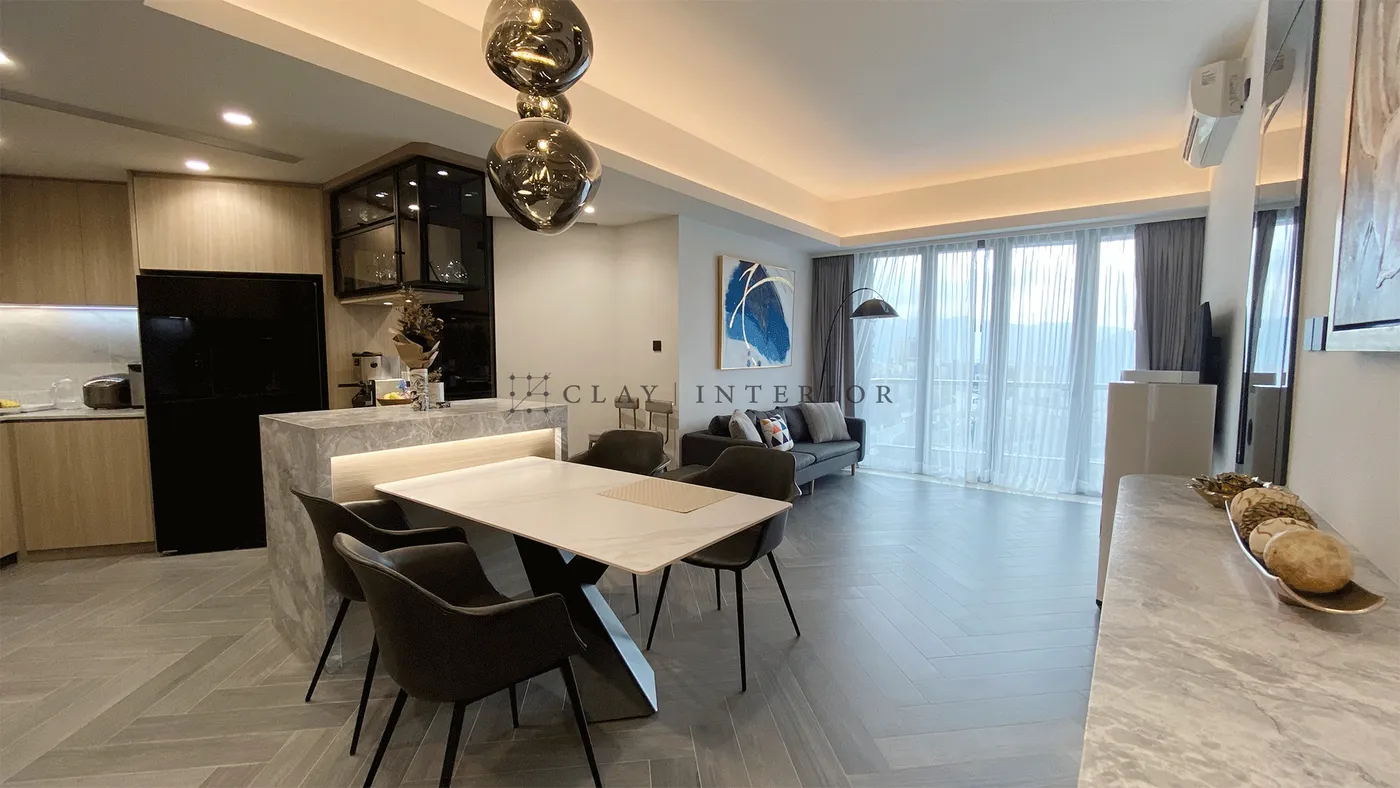 Open-plan living and dining area with floor-to-ceiling glass doors framing the city view