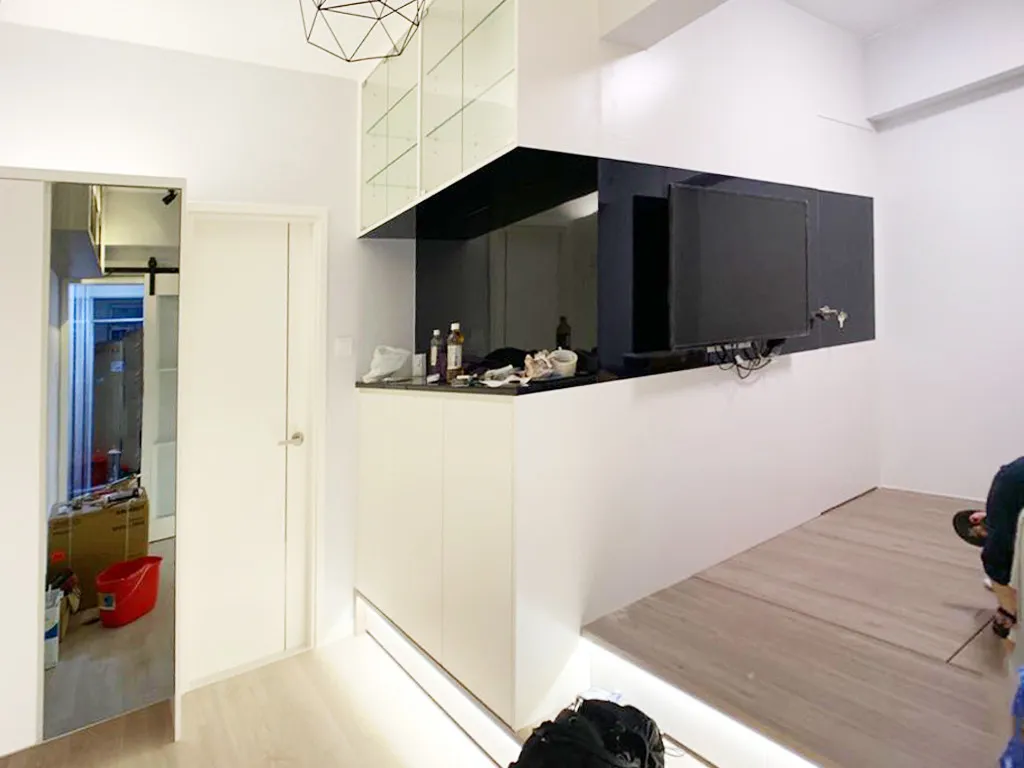 Living room TV feature wall in black finish with white storage cabinetry
