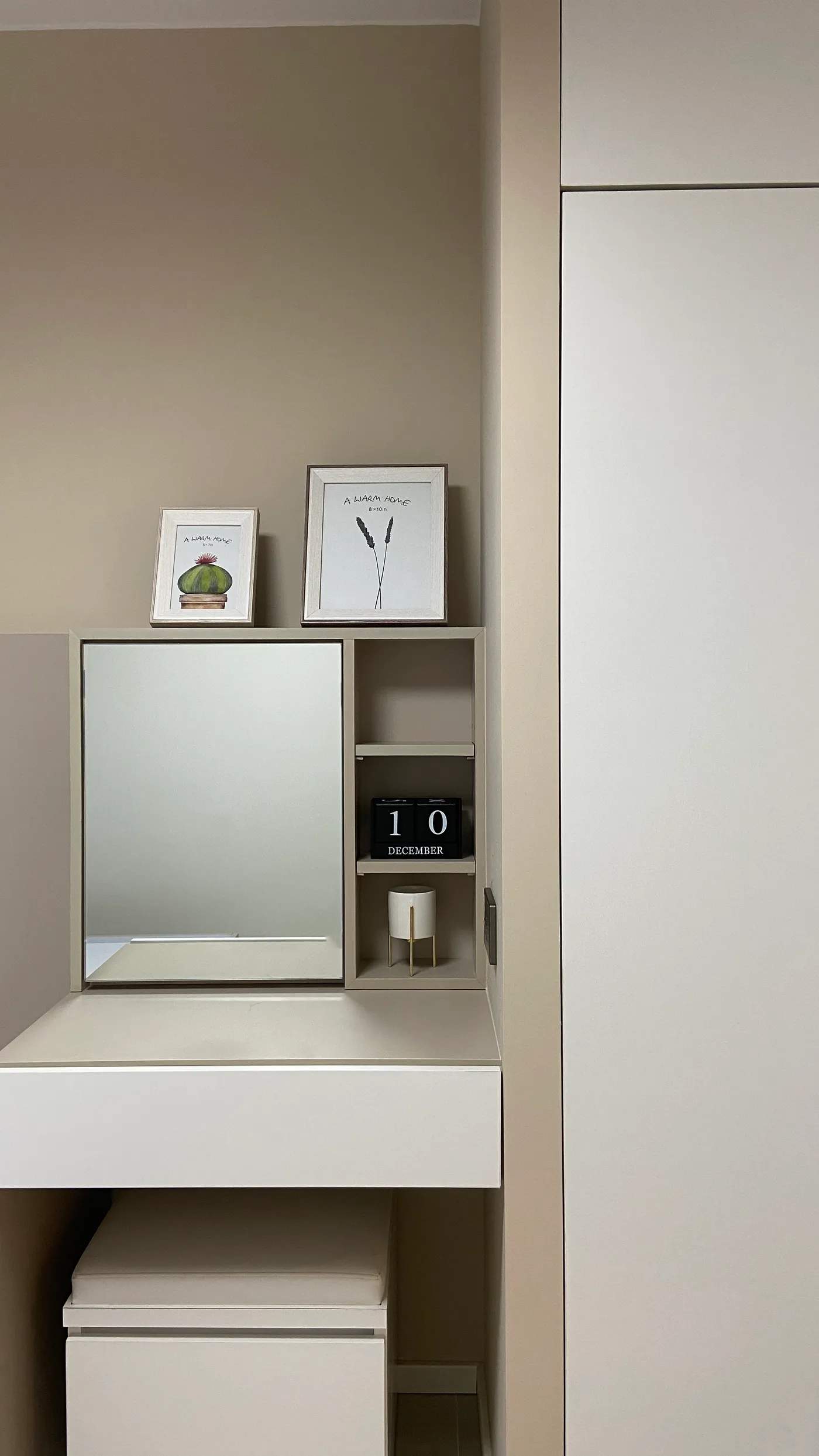 Bedroom vanity corner with a mirror cabinet and shelf storage